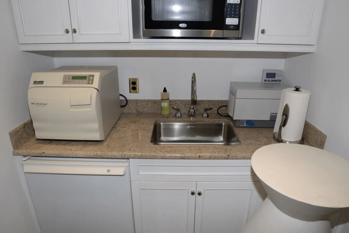 Bathroom: EFTA00001866 - Compact kitchenette with a microwave sink and countertop appliances includi