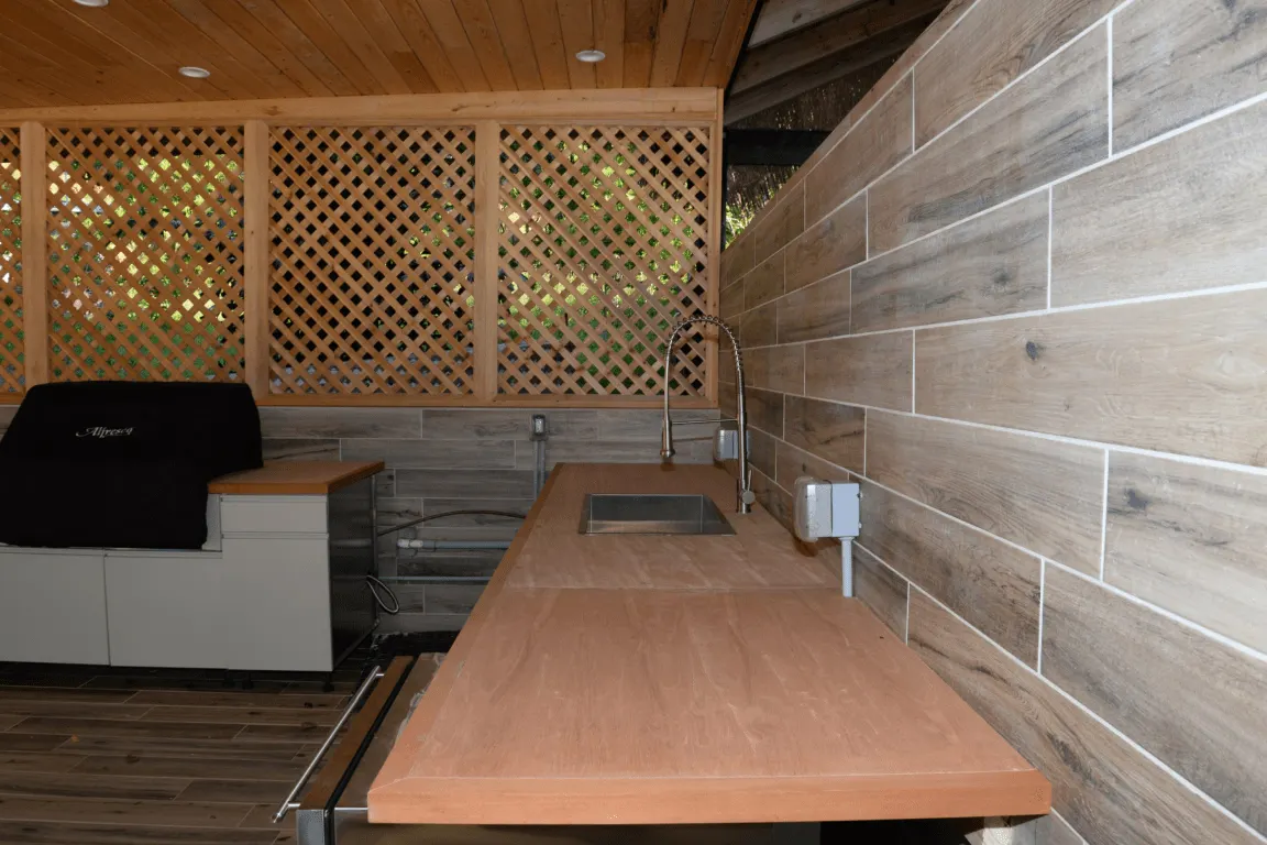 Bathroom: EFTA00002814 - Wooden countertop with sink and grill under lattice wall