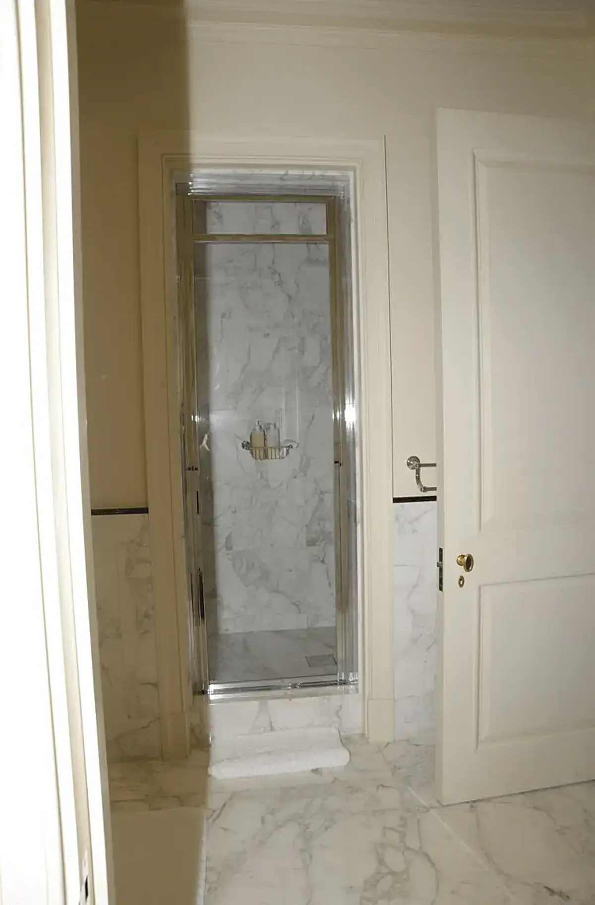 Baño: EFTA00000243 - Modern bathroom featuring a glass shower enclosure with marble walls comple