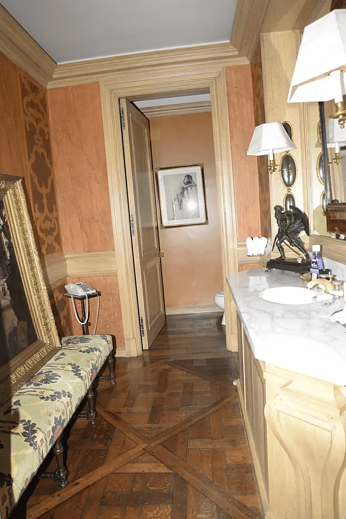 Bathroom: EFTA00000685 - Luxurious bathroom with wooden floors ornate walls a marble countertop and 
