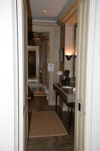 Bagno: EFTA00000903 - Luxurious bathroom hallway with marble flooring ornate mirrors and elegant 