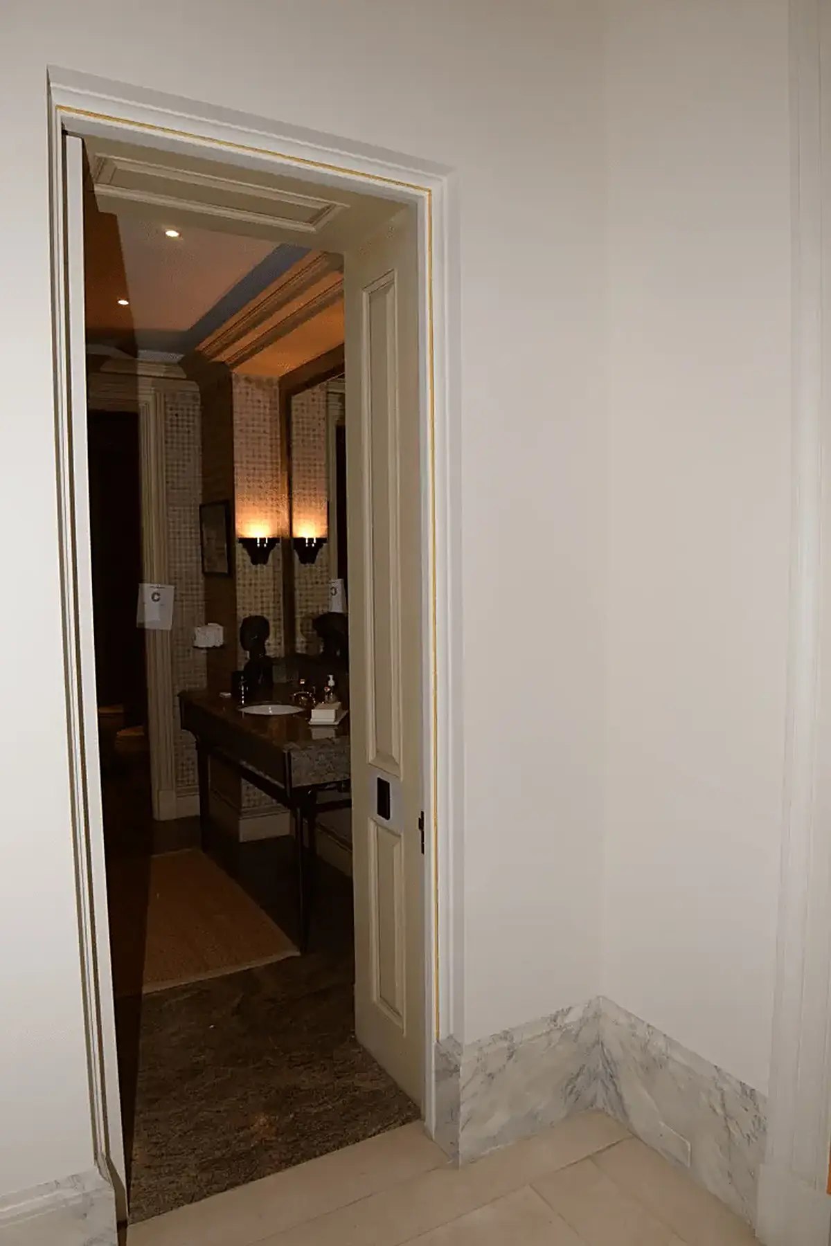 Bathroom: EFTA00000911 - Doorway leads into a luxurious bathroom featuring a marble countertop elega