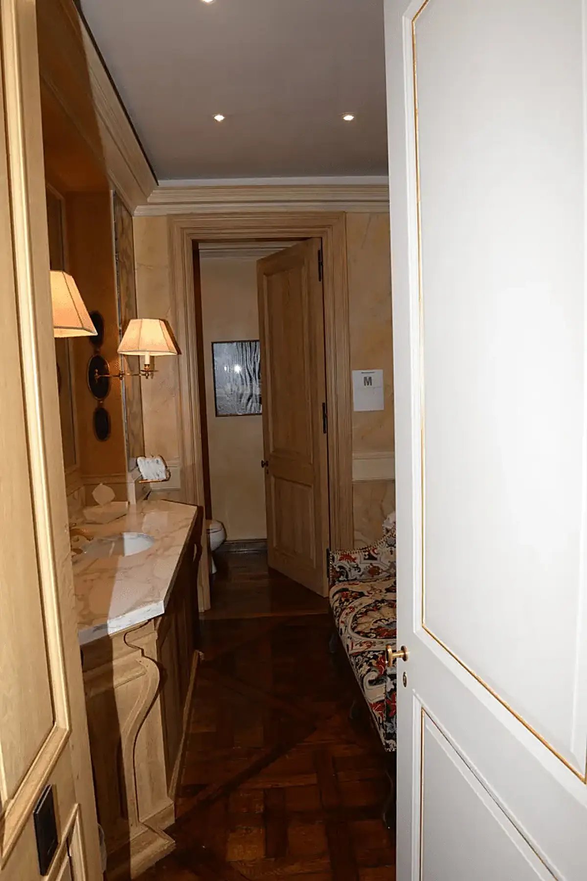 Bathroom: EFTA00001436 - Luxurious bathroom with wooden floors ornate woodwork a marble countertop a