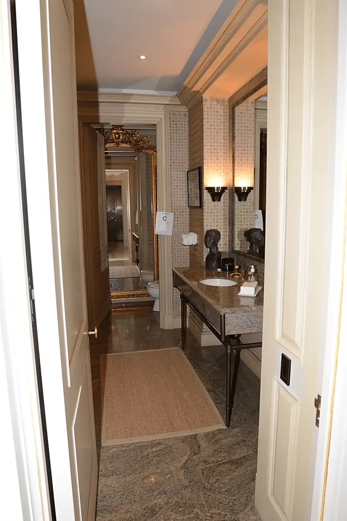 Bathroom: EFTA00001454 - Luxurious bathroom hallway with marble flooring a granite countertop ornate