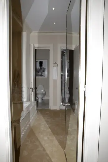 Bagno: EFTA00000272 - Modern bathroom viewed through an open doorway featuring a marble counterto