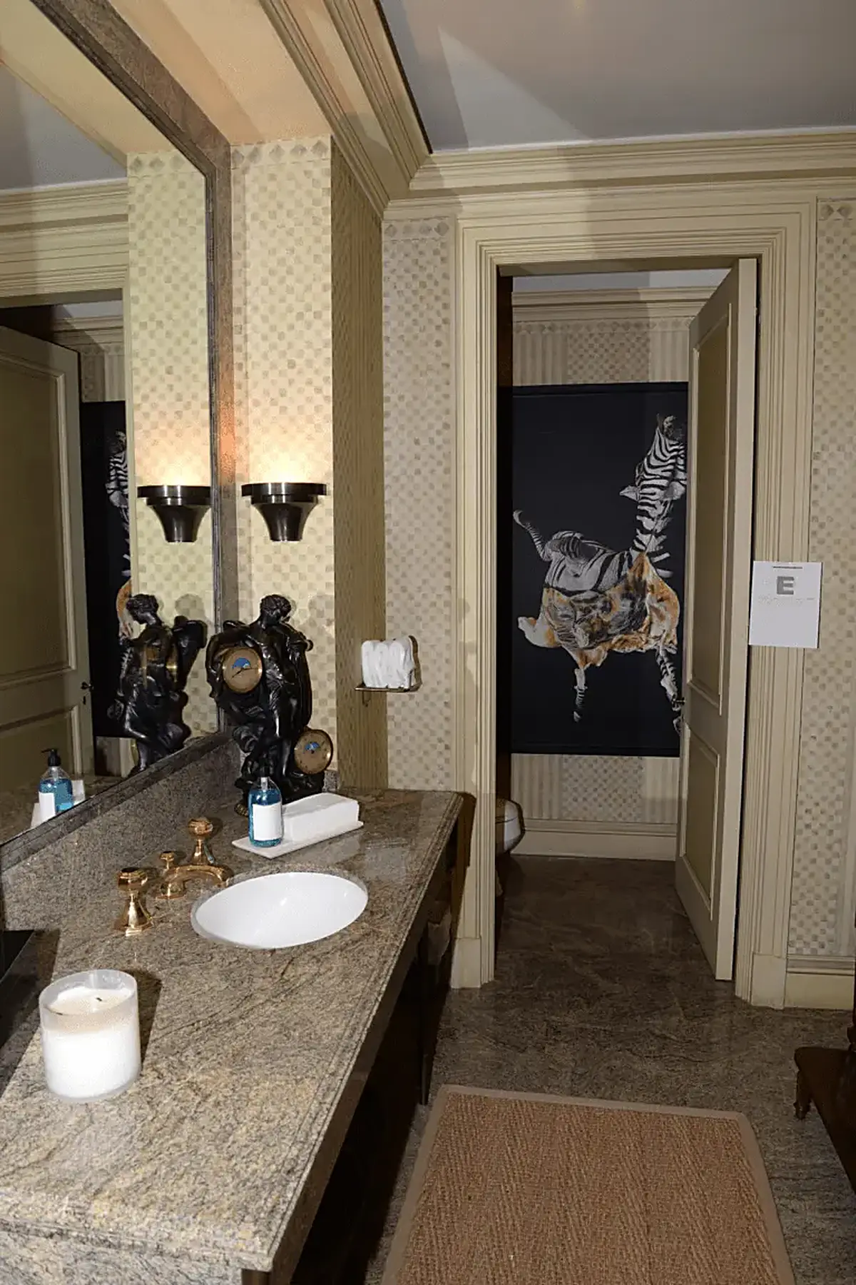Bathroom: EFTA00000936 - Luxurious bathroom featuring a granite countertop ornate fixtures and a str