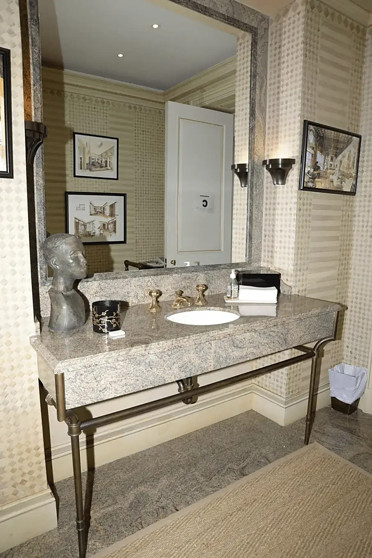 Bathroom: EFTA00000048 - Elegant bathroom vanity with marble countertop brass fixtures and patterned