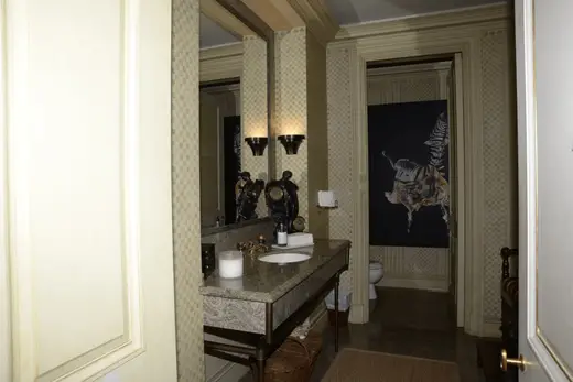 Bagno: EFTA00000059 - Elegant bathroom features a marble countertop ornate mirror and patterned w
