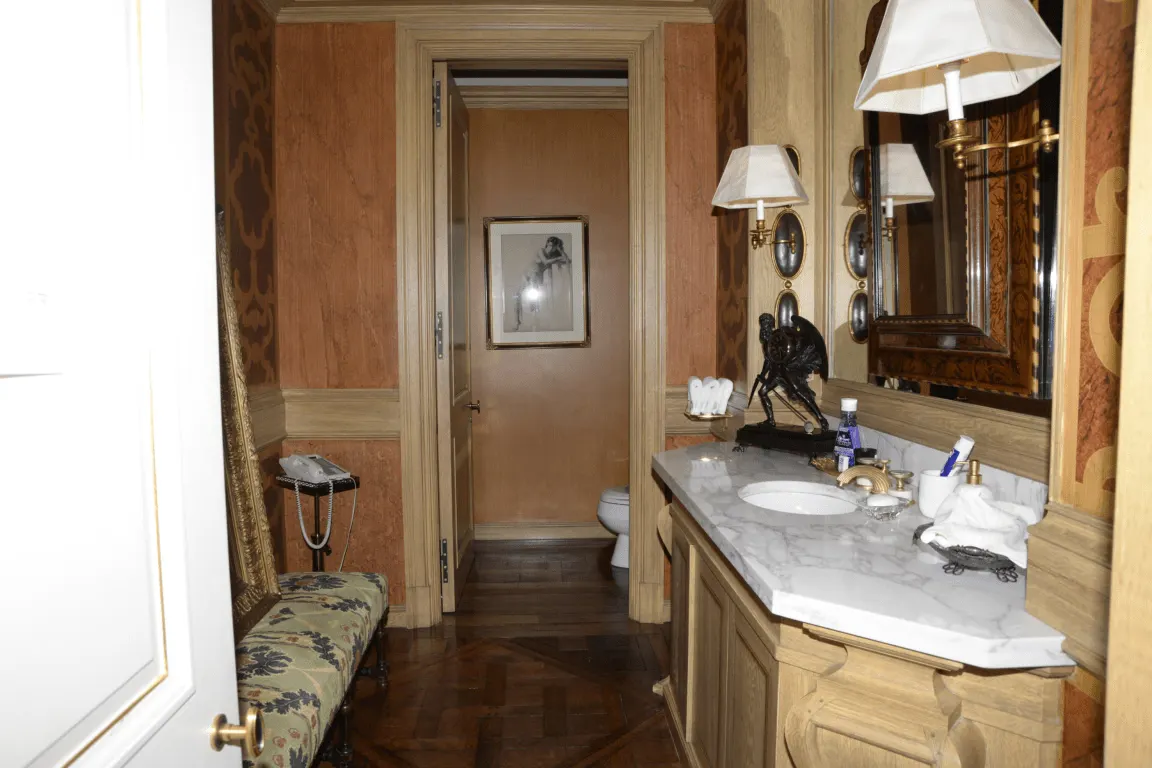 Bathroom: EFTA00000138 - Luxurious bathroom with ornate wood paneling marble countertop and vintage-
