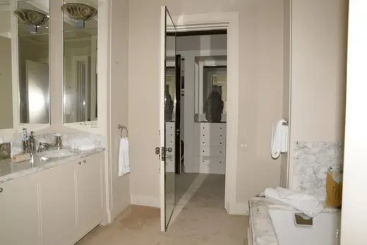 Bagno: EFTA00000274 - Modern bathroom with white cabinets marble countertops and large mirrors fe