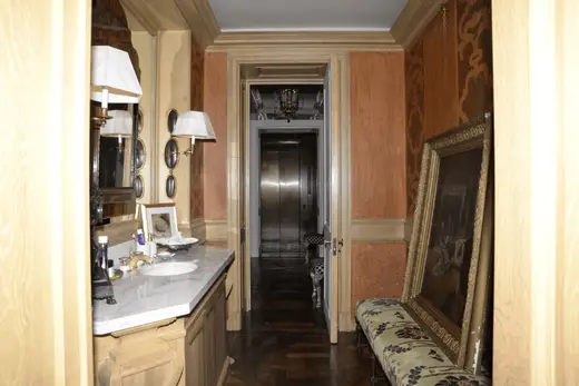 Bagno: EFTA00000143 - Elegant bathroom with marble countertop ornate mirror wooden cabinets and p
