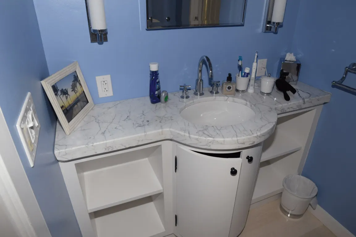 Bathroom: EFTA00001791 - Bathroom with blue walls white vanity marble countertop and a sink featurin