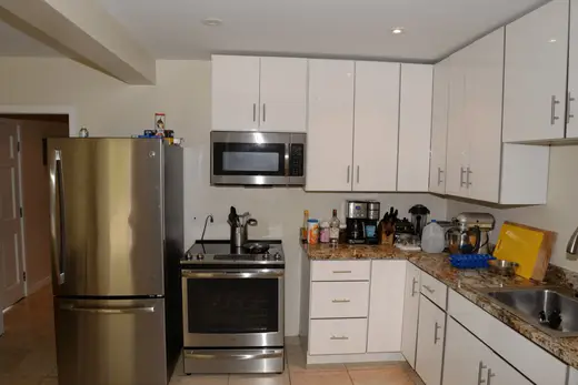 Bagno: EFTA00002129 - Modern kitchen with stainless steel appliances white cabinets granite count
