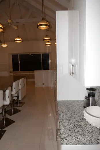 Kitchen: EFTA00002062 - Modern kitchen with white cabinets granite countertop and pendant lights un