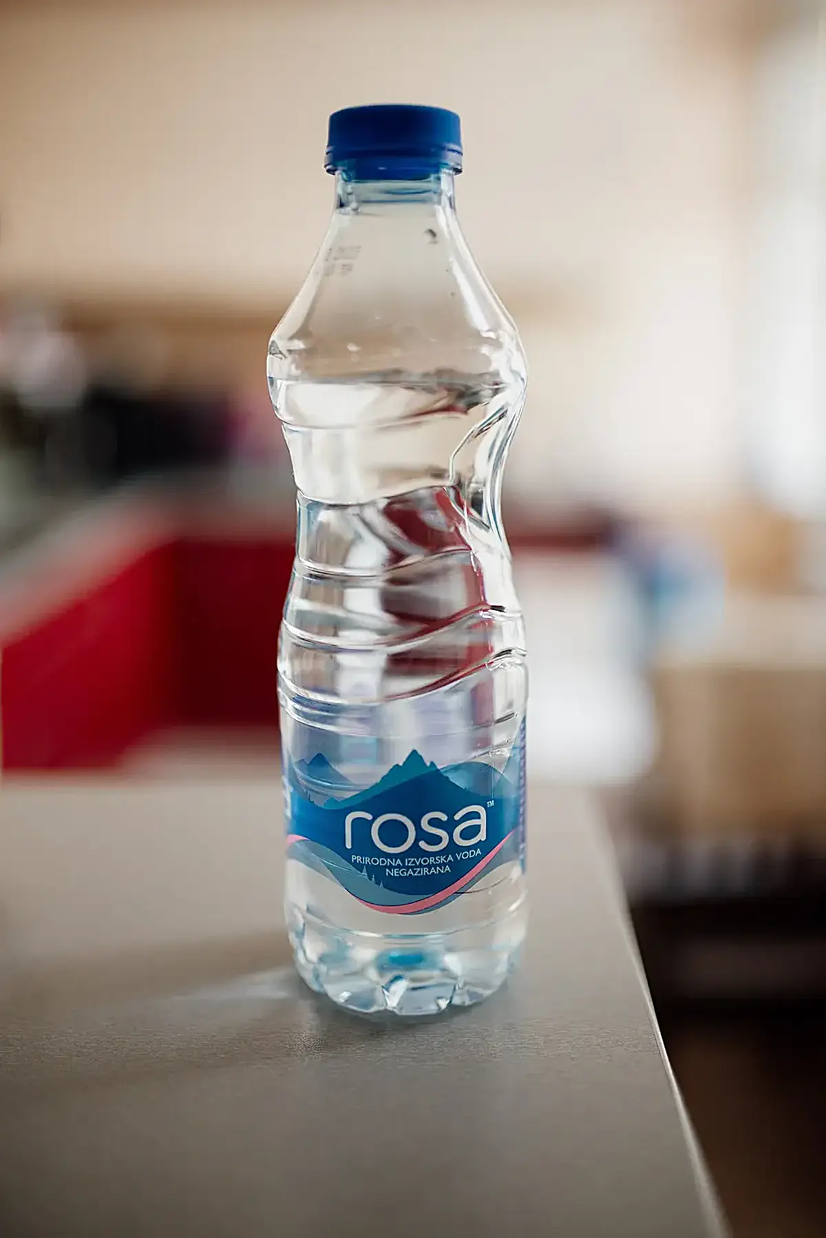 Cucina: Clear bottle of natural mineral water placed on a countertop in a bright kitchen setting