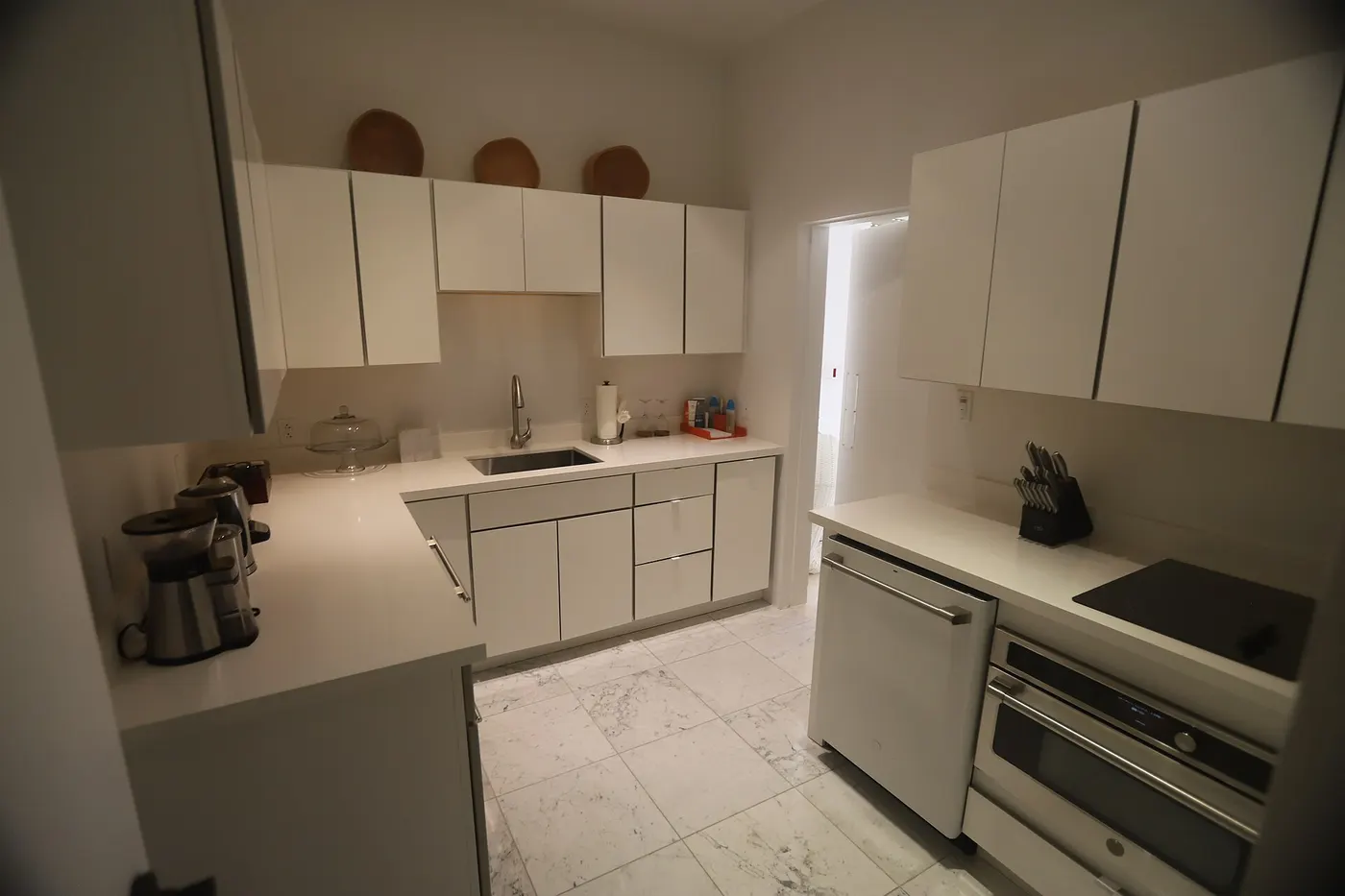 Kitchen: USVI IMG 5429 - Modern white kitchen with sleek cabinets marble floor and stainless steel